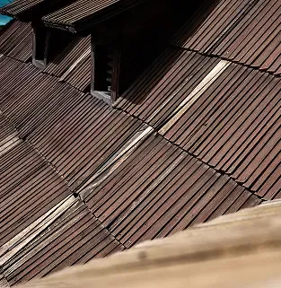 Faded brown shingles before replacement.
